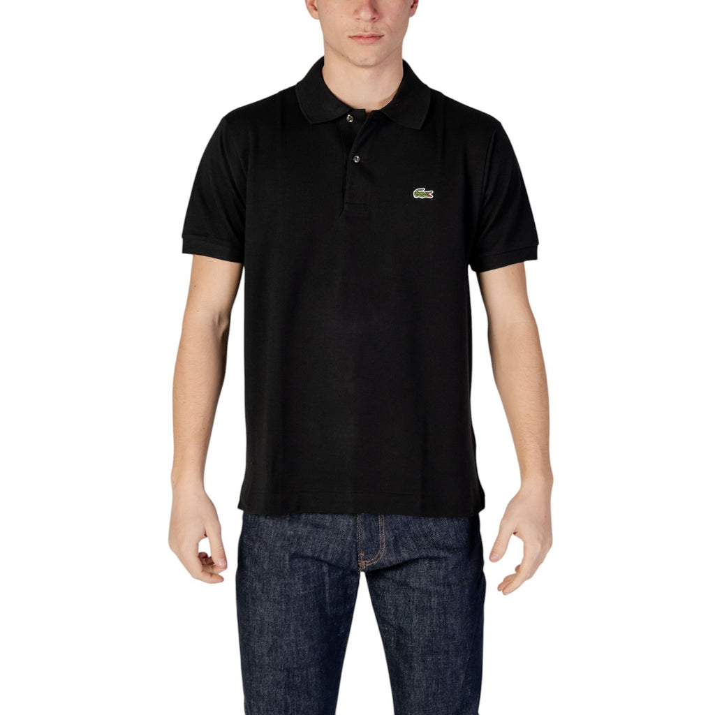 Man wearing a black polo shirt with short sleeves and blue jeans on white background